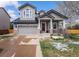Charming two-story home featuring a covered front porch, well-maintained lawn, and attached two car garage at 9407 W Gibraltar Pl, Littleton, CO 80127