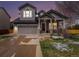 Charming two-story home with a two-car garage, covered porch, and mature trees at 9407 W Gibraltar Pl, Littleton, CO 80127