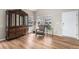 Bright living room with wood flooring, a chair, large wooden china cabinet, and plenty of natural light at 9407 W Gibraltar Pl, Littleton, CO 80127