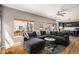 Spacious living room featuring modern furnishings and a large window offering view of the home's exterior at 9407 W Gibraltar Pl, Littleton, CO 80127