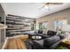 Comfortable living room with wood plank wall, modern sectional sofa, and natural light from several windows at 9407 W Gibraltar Pl, Littleton, CO 80127