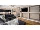 Comfortable living room with a fireplace, television, views to the kitchen and an extra large sectional sofa at 9407 W Gibraltar Pl, Littleton, CO 80127