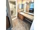 Well-lit bathroom featuring a double vanity, mirror, and glass door shower at 5343 S Ukraine Way, Aurora, CO 80015