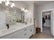 Elegant bathroom with dual sinks, white cabinetry, and a walk-in closet at 1933 W 165Th Way, Broomfield, CO 80023