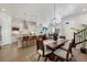 Open concept dining area with modern light fixture next to the kitchen and living room at 1933 W 165Th Way, Broomfield, CO 80023