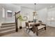 Dining room with wood table, neutral rug, and staircase at 1933 W 165Th Way, Broomfield, CO 80023