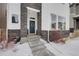 Inviting front entrance with blue door, stone accents, and a charming wreath at 1933 W 165Th Way, Broomfield, CO 80023