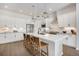 Bright kitchen featuring white cabinetry, stainless steel appliances, and an island with barstool seating at 1933 W 165Th Way, Broomfield, CO 80023