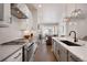 Modern kitchen flowing into living space, with stainless appliances and a large kitchen island at 1933 W 165Th Way, Broomfield, CO 80023