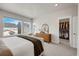 Bright main bedroom with large windows, a dresser, and a walk-in closet at 1933 W 165Th Way, Broomfield, CO 80023