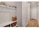 Mud room with white shelving, storage, coat hooks and wood floors at 1933 W 165Th Way, Broomfield, CO 80023