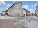 Street view of newly constructed townhomes featuring attached garages, and modern color schemes at 1933 W 165Th Way, Broomfield, CO 80023