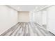 Spacious finished basement featuring LVP flooring, neutral paint and bright lighting at 2340 Jamaica St, Aurora, CO 80010