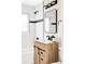 Updated bathroom featuring a wood vanity, black accents, and updated shower/tub at 2340 Jamaica St, Aurora, CO 80010