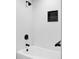 Bathroom with black shower head, black-tiled shelf, and white subway tile at 2340 Jamaica St, Aurora, CO 80010