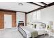 Cozy bedroom with a fireplace, exposed beams, a large window and neutral décor at 2340 Jamaica St, Aurora, CO 80010
