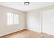 Unfurnished bedroom with hardwood floors and neutral paint and a side window at 2340 Jamaica St, Aurora, CO 80010
