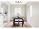 Modern dining room featuring a sleek black table and chairs, with bright natural light at 2340 Jamaica St, Aurora, CO 80010