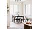 Charming dining area with a modern black table and chairs, bathed in natural light at 2340 Jamaica St, Aurora, CO 80010