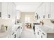 Bright kitchen with white cabinets, stainless appliances, stone countertops and a nearby dining area at 2340 Jamaica St, Aurora, CO 80010