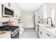 Bright kitchen with stainless steel appliances, white cabinets, stone countertops and modern fixtures at 2340 Jamaica St, Aurora, CO 80010