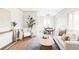 Inviting living area featuring hardwood floors, a comfortable sofa, and a view into the dining room at 2340 Jamaica St, Aurora, CO 80010