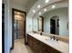 Bathroom boasts double sinks, a large mirror, and a walk-in shower at 662 Yankakee, Castle Rock, CO 80108