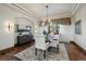 Elegant dining room features hardwood floors, a chandelier, and large windows at 662 Yankakee, Castle Rock, CO 80108