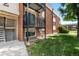 Side angle exterior of the brick apartment building and landscaped green space at 5995 W Hampden Ave # 3E, Denver, CO 80227