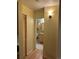Hallway leading to bathroom with tile floors and a storage closet at 5995 W Hampden Ave # 3E, Denver, CO 80227