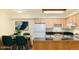 Cozy kitchen and dining area featuring a sleek black countertop, white appliances, and ample cabinet space at 5995 W Hampden Ave # 3E, Denver, CO 80227