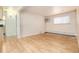Bright living room with hardwood floors, a window, and an air conditioning unit at 5995 W Hampden Ave # 3E, Denver, CO 80227