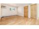 Open living room features hardwood floors, a window, an air conditioner, and closet space at 5995 W Hampden Ave # 3E, Denver, CO 80227