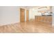 Empty living room showing hardwood floors and an open layout to the kitchen and closet at 5995 W Hampden Ave # 3E, Denver, CO 80227