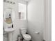 Bathroom featuring a pedestal sink, commode, and shower with curtain at 24333 E 41St Ave, Aurora, CO 80019