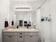 Bathroom features double sink vanity with mirror and tiled shower with curtain at 24333 E 41St Ave, Aurora, CO 80019