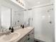 Bathroom features double sink vanity with mirror and tiled shower with white tiles at 24333 E 41St Ave, Aurora, CO 80019