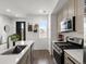 Modern kitchen featuring stainless steel appliances and an island with a sink at 24333 E 41St Ave, Aurora, CO 80019