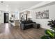 View of the living room with open access to the modern kitchen and breakfast bar seating at 24333 E 41St Ave, Aurora, CO 80019