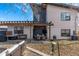 A backyard with dining and seating areas under a pergola at 745 S Eliot St, Denver, CO 80219