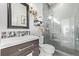 Modern bathroom featuring a glass-enclosed shower, stylish vanity, and decorative touches at 745 S Eliot St, Denver, CO 80219