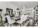 Bright dining room with high ceilings, modern decor, and an open view to the kitchen at 745 S Eliot St, Denver, CO 80219