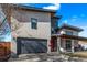 Striking modern home with a gray garage door, stylish stonework, and a well-manicured lawn at 745 S Eliot St, Denver, CO 80219