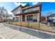 Attractive modern home showcasing a covered front porch, gray garage, and sleek architectural details at 745 S Eliot St, Denver, CO 80219