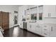 Modern kitchen featuring stainless steel appliances, white countertops, subway tile backsplash, and a wooden barn door at 745 S Eliot St, Denver, CO 80219