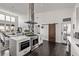 Modern kitchen featuring stainless steel appliances, white countertops, and wood accent barn door at 745 S Eliot St, Denver, CO 80219