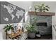 Chic living room featuring a modern fireplace, stylish bar cart, and plenty of plants at 745 S Eliot St, Denver, CO 80219