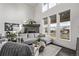 Elegant living room with high ceilings, large windows, a stone fireplace, and comfortable gray seating at 745 S Eliot St, Denver, CO 80219