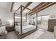 Bright main bedroom with a four poster bed, exposed beams, and natural light at 745 S Eliot St, Denver, CO 80219