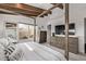 Bright main bedroom boasting a four poster bed, exposed beams, and natural light at 745 S Eliot St, Denver, CO 80219